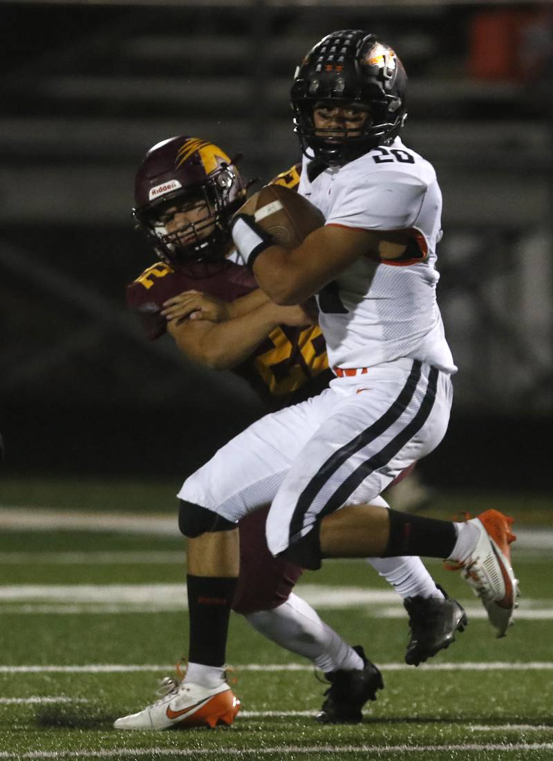 Richmond-Burton's Gavin Busa tackles Sandwich's Diego Gomez during a Kishwaukee River Conference football game on Friday, Oct. 4, 2024, at Richmond-Burton High School.