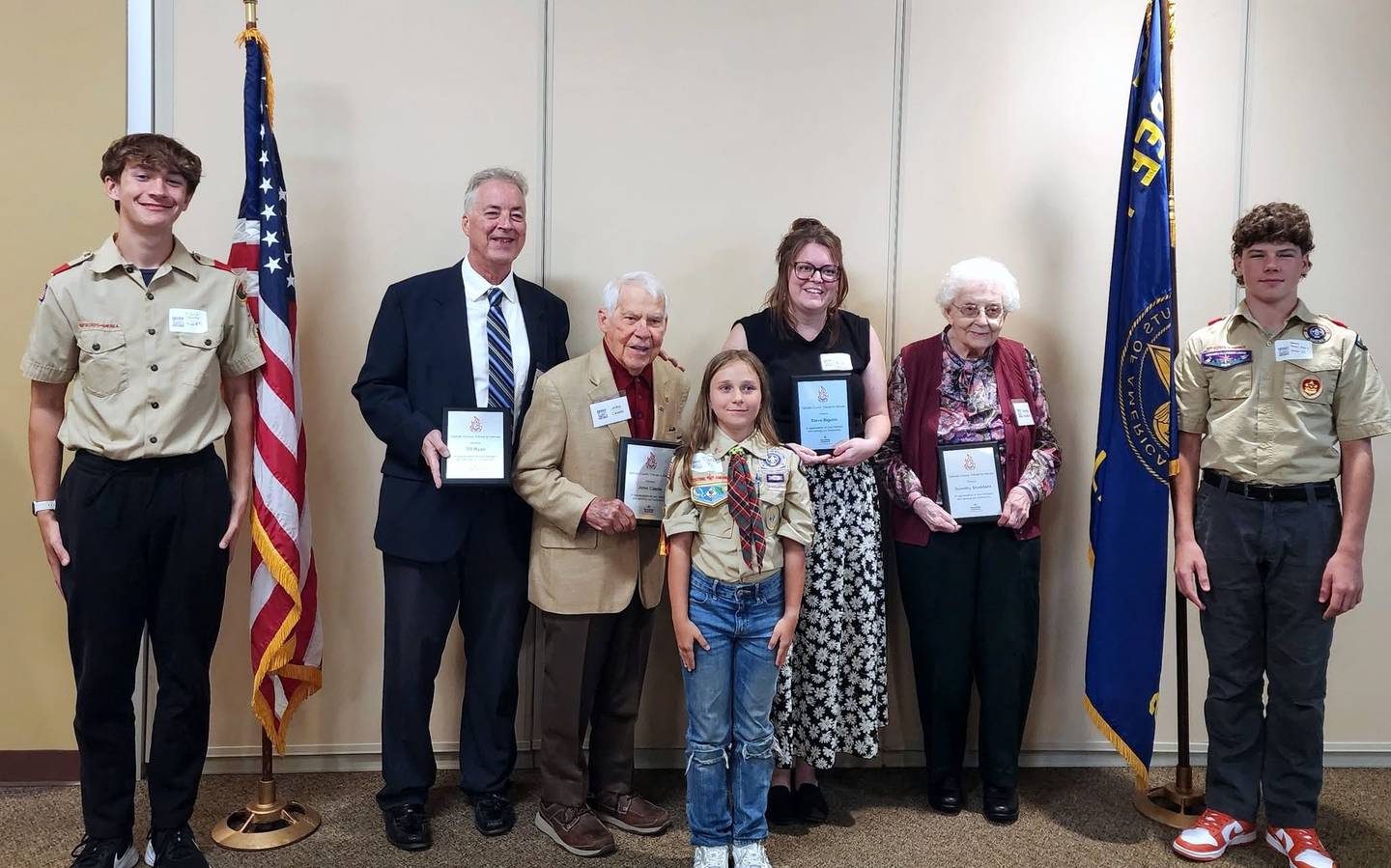 J.F. Glidden Homestead and Historical Center executive director Jessi Haish LaRue (third from right) stands in for Steve Bigolin in acceptance of an award bestowed upon him by Boy Scout Troop 33.