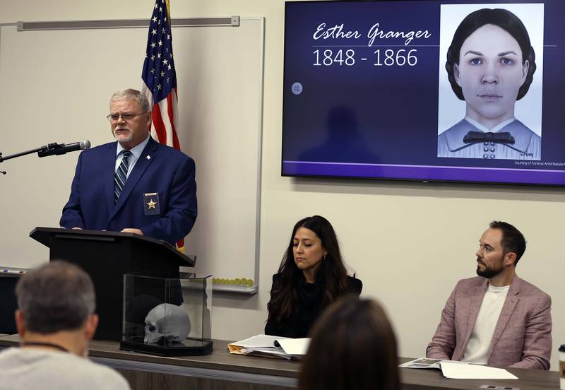 Kane County Coroner Rob Russell is pictured with an artist’s rendering of the likeness of Esther Granger as he speaks during a press conference Thursday, Oct. 24, 2024 in St. Charles. In 1978 a skull was found in a wall of a house being remodeled in Batavia. Last year Batavia police found it in their cold case evidence, and asked the coroner for help identifying it. They extracted DNA and had it analyzed by a forensic genetic genealogy company. Also pictured are Deputy Kane County Coroner Gabriela Allison, center, and Michael Vogen, Director of Account Management, Othram.
