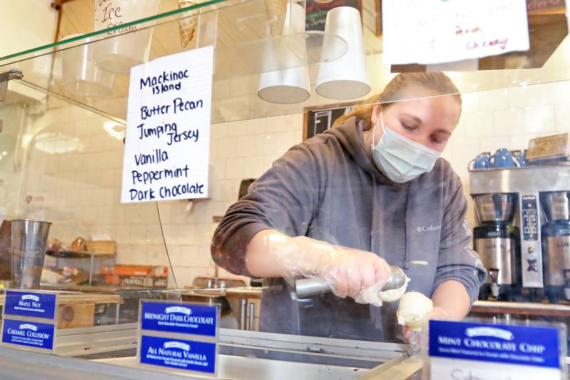 General Store employee Chloe Scott scoops ice cream inside the store on Tuesday, Dec. 15, 2020, in Greenwood. The building has been a general store since its construction in 1894 and was also the township's post office.
