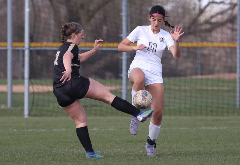 Sycamore's Anya Berry tries to kick the ball by Kaneland's Corinne Faivre during their game Monday, April 14, 2025, at Sycamore High School.