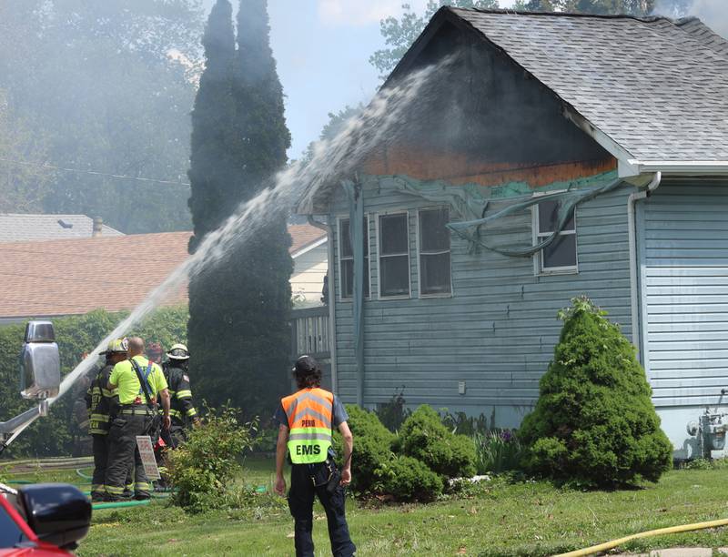 Firefighters spray water on a structure fire in the 1900 block of Main Street on Monday, May 4, 2026 in Peru.