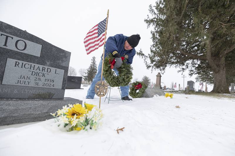 Doug Near places a wreath on a veteran’s headstone Saturday, Dec. 13, 2025, at Palmyra Cemetery in Dixon. Wreaths Across America is a nationwide effort to recognize veterans interred at their local cemeteries. The DAR of Rochelle held their first ever ceremony in Dixon.