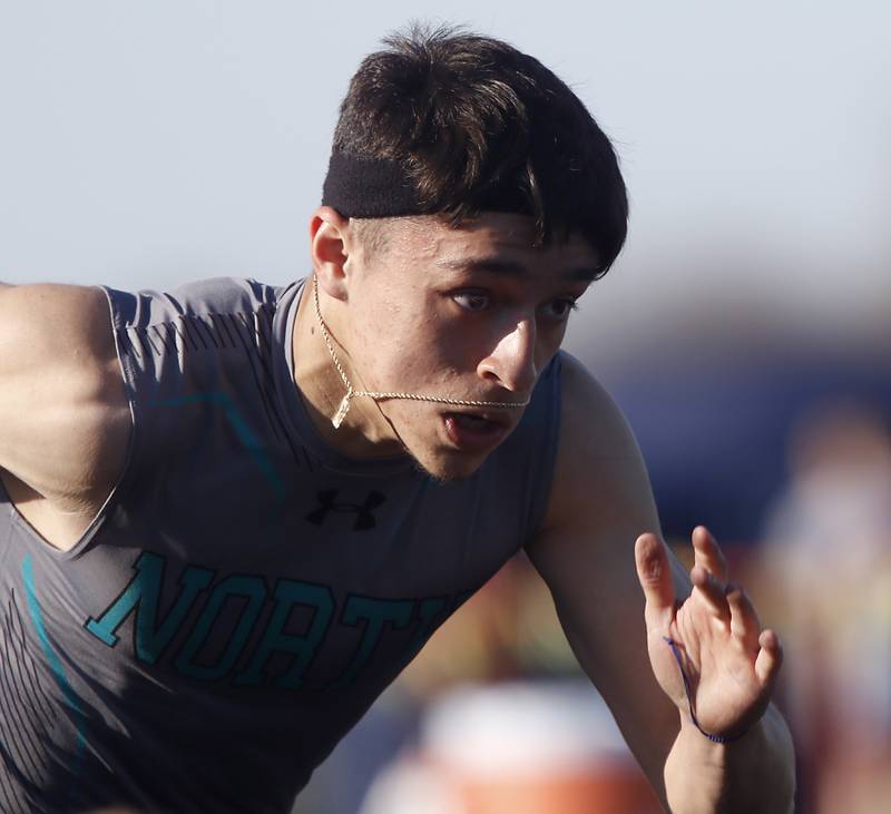 Woodstock North’s Chris Carrreno blasts out of the blocks as he runs the first leg of the 4X100 relay Thursday, April 21, 2022, during the McHenry County Track and Field Meet at Richmond-Burton High School.