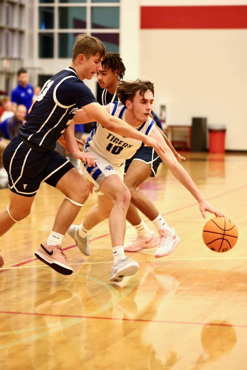 Princeton's Gavin Lanham gets past Fieldcrest's Jordan Reinhardt for a layup Tuesday night at Hall High School.