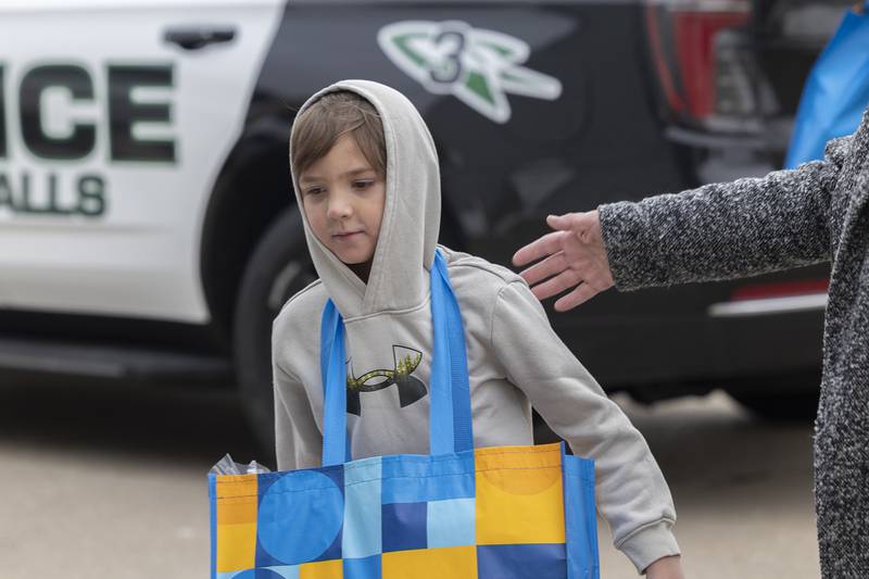 Connor, 6, hauls in groceries Monday, Dec. 22, 2025, as Operation Santa makes a stop at his home.