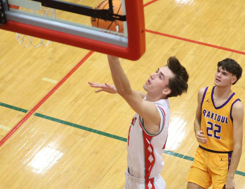 L-P's. Wyatt Kilday runs in to score on a layup over Rantoul's Spencer Stockwill on Friday, Dec. 19, 2025 in Sellett Gymnasium at L-P High School.