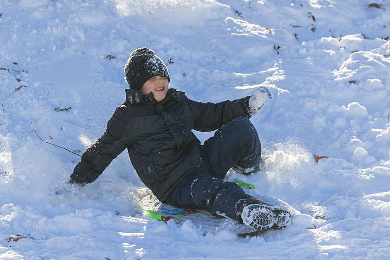 Zayne Swan, 10, skids down the hill Sunday, Nov. 30, 2025, at EC Smith Park in Dixon.