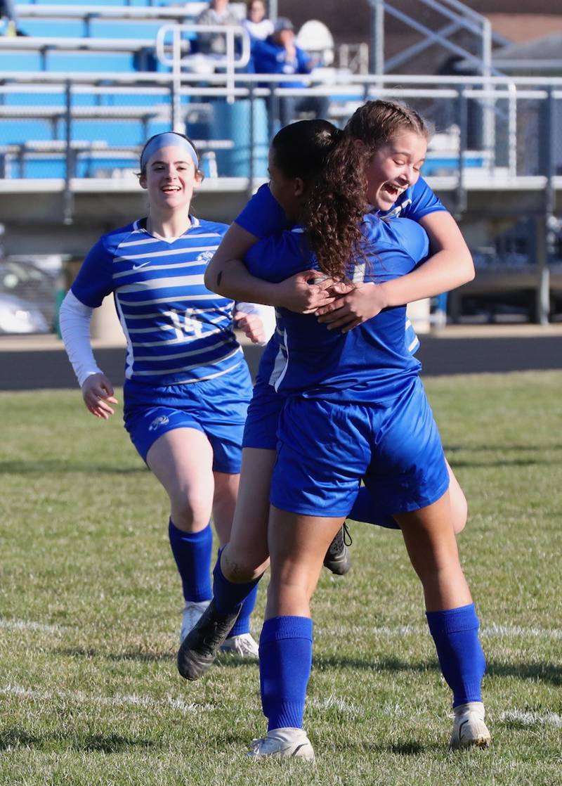 Mariah Hobson gives teammate Olivia Mattingly a hug after she scored a goal Tuesday.