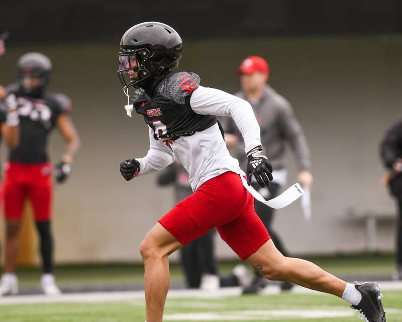 Northern Illinois University Nate Valcarcel helps the defense during practice on Saturday March 30, 2024, held at Huskie Stadium in DeKalb.