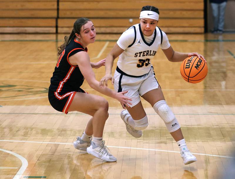 Sterling's Joslynn James drives by Crystal Lake Central's Sammi Pottorff during their Class 3A sectional semifinal game Tuesday, Feb. 25, 2025, at Boylan Catholic High School in Rockford.