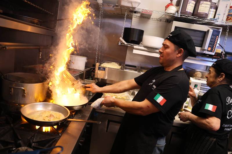 Chef Juan Rodriguez prepares a flambé chicken order at Big Sammy’s Italian Eatery in downtown Plainfield. Friday, Feb. 25, 2022, in Plainfield.