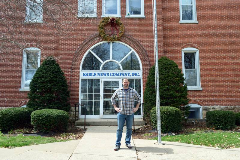 John Russell, of rural Mt. Morris, poses for a photo outside the former Kable News Company building on the Mt. Morris campus on April 20, 2023. Russell closed on the purchase of the building on March 1; he plans to restore and modify it into multi-use space that benefits the community.