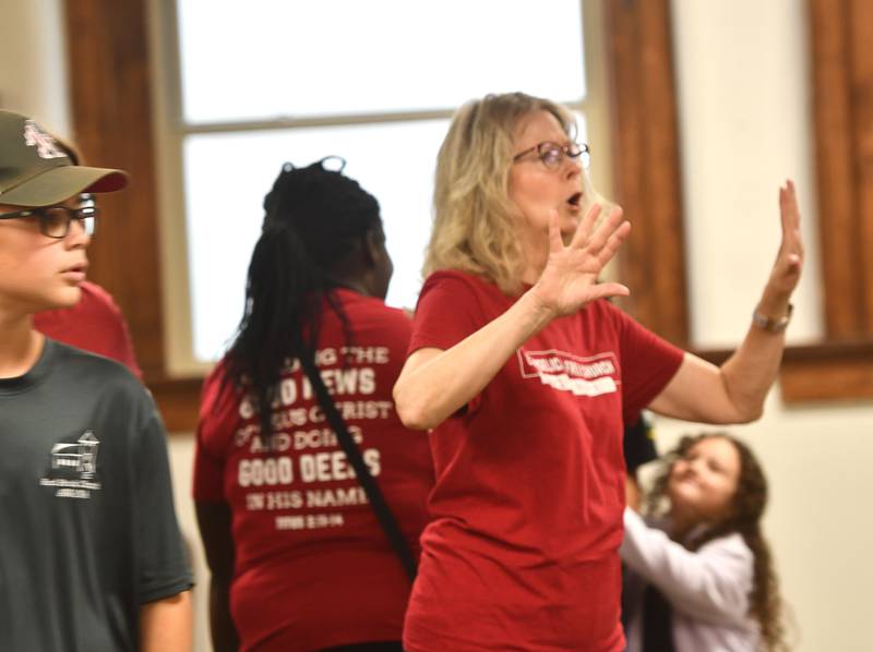 Joyce Long, chairman of the Outreach Team for the Evangelical Free Church of Mt. Morris, directs volunteers on Thursday, Oct. 16, 2025 as they assemble care packages for sailors serving on the USS Fitzgerald.