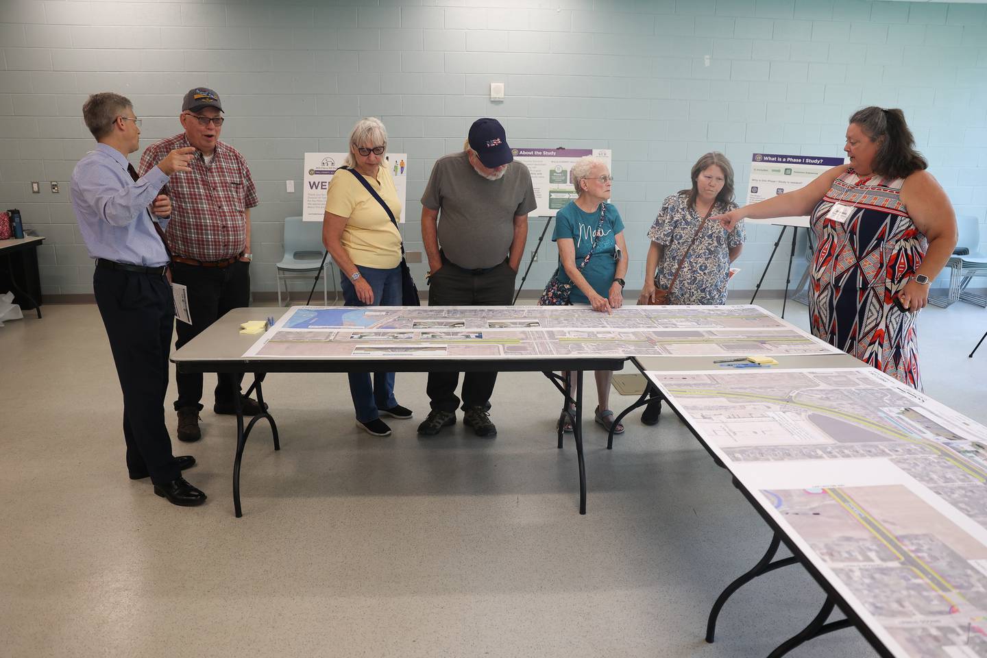 People look over maps of the proposed road improvements along Mills Road and Cherry Hill Road during an open house on the Mill-Cherry Hill Road Study at the Nowell Park Recreation Center in Joliet on Tuesday, July 30, 2024.