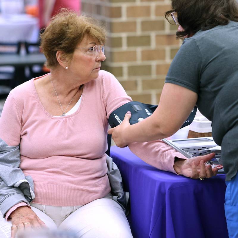 Elsie Morrissey, from Sandwich, has her blood pressure taken at the Northwestern Medicine booth during a senior health fair Wednesday, July 12, 2023, at DeKalb High School. The event was hosted by local state legislators.