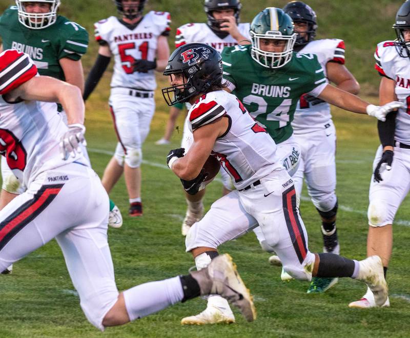 Erie-Prophetstown's Jase Grunder runs the ball as St. Bede's Gavin Marquez (24) chases him Friday, Sept. 2, 2022 in Peru.