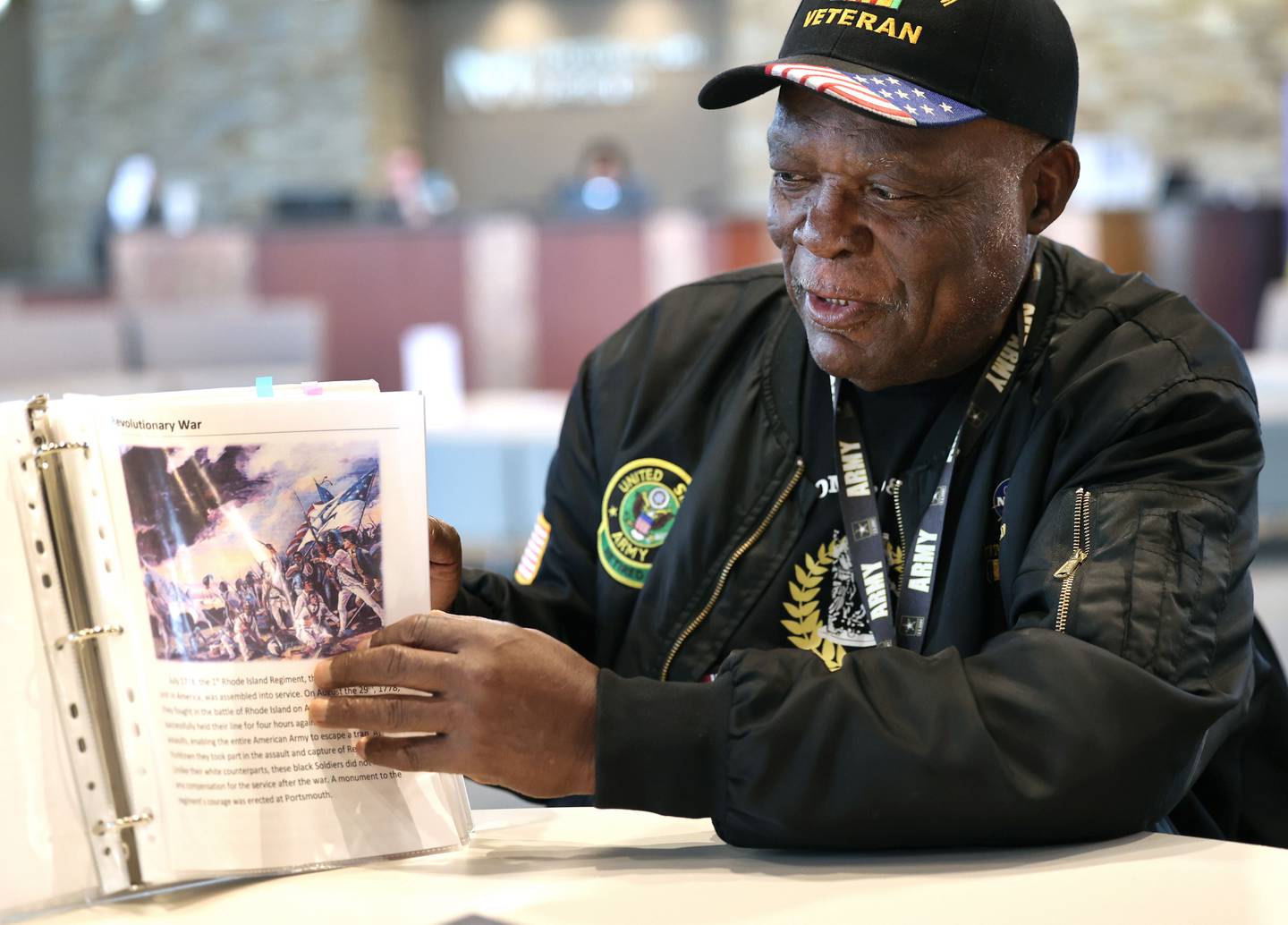 Daniel "Doc" Habeel, a U.S. Army veteran from DeKalb, flips through a book Tuesday, Sept. 19, 2023, at the Northwestern Medicine Kishwaukee Health & Wellness Center in DeKalb, that he put together that highlights Black veterans and activists who made significant contributions to the country. Habeel along with his late wife, Arnetha Gholston-Habeel, opened a veterans center in Chicago that has since closed.