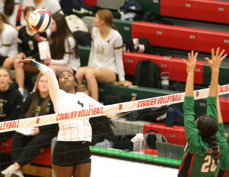 Sycamore's Khiara Thomas spikes the ball past L-P's Ava Currie on Tuesday, Oct. 15, 2024 in AJ Sellett Gymnasium at L-P High School.
