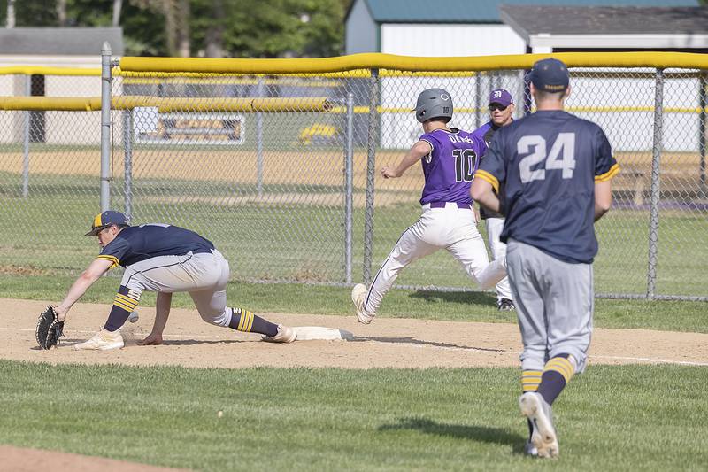 Sterling’s Mason Smithee is unable to grab a low throw at first as Dixon’s Bryce Feit makes it safely Tuesday, May 16, 2023.