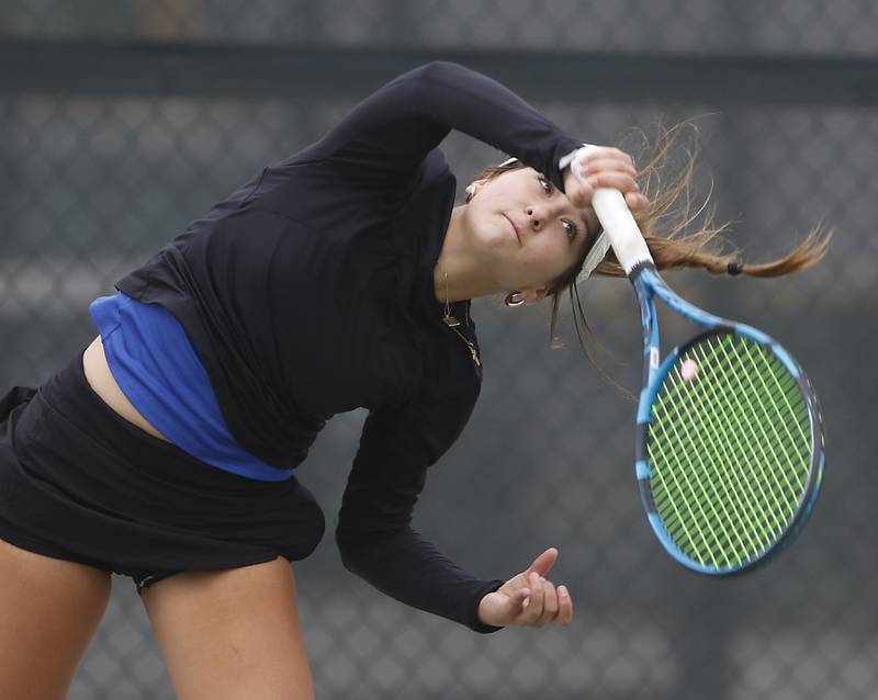 St. Charles North’s Danielle Dejanovich watches her serve Thursday, Oct. 19, 2023, during doubles match on the first day of the IHSA State Girls Tennis Tournament at Hoffman Estates High School in Hoffman Estates.