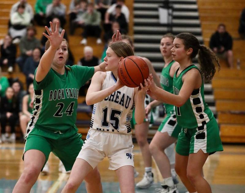 Bureau Valley junior Taylor Neuhalfen finds herself surrounded by Rock Falls Rockets Peyton Smit (24) and Elizabeth Lombardo (1) in Saturday's regional game at the Storm Cellar.