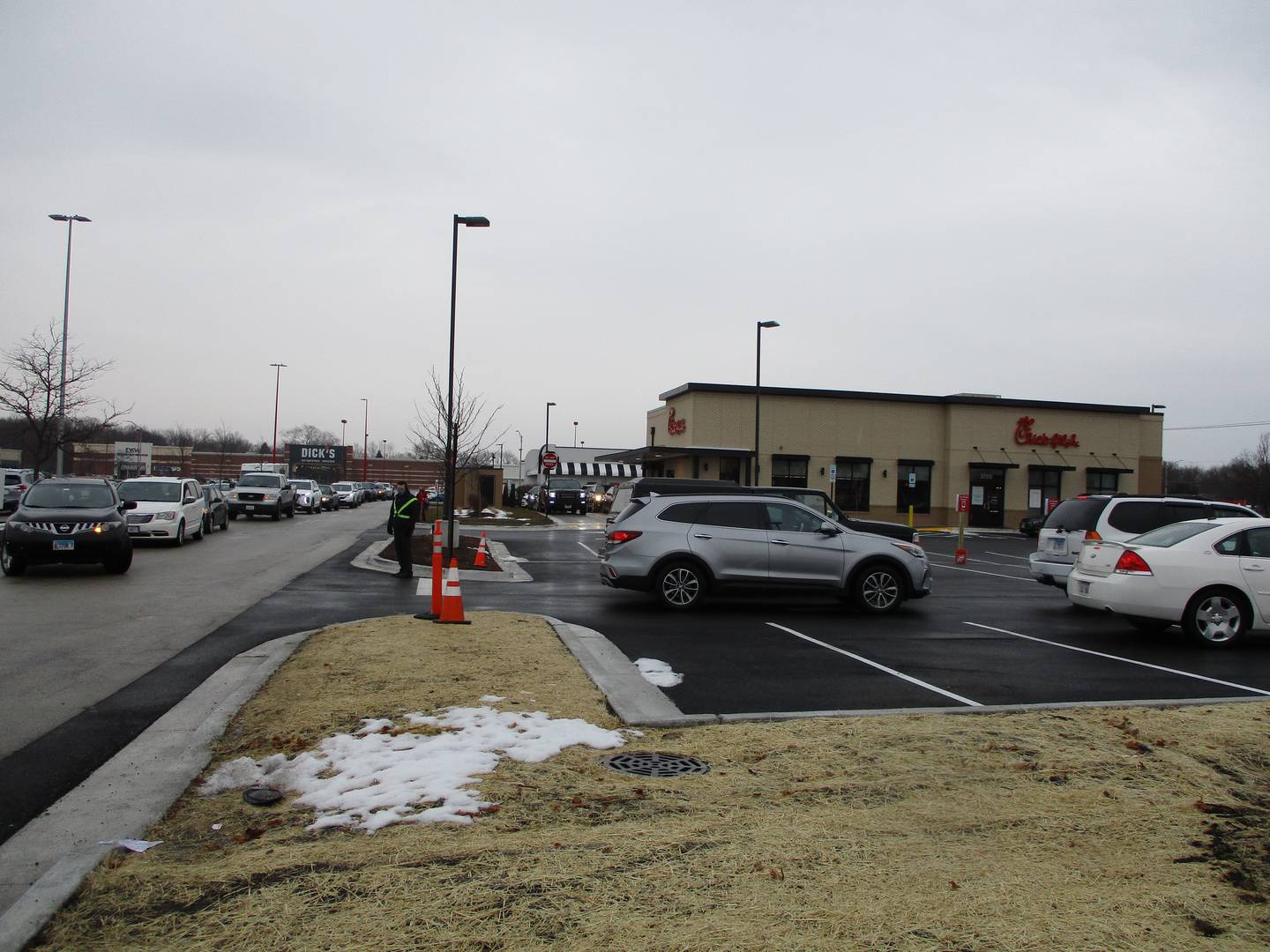 The line of cars for the opening day of  Chick-fil-A in Joliet on Thursday stretches into the Joliet Commons parking lot.
