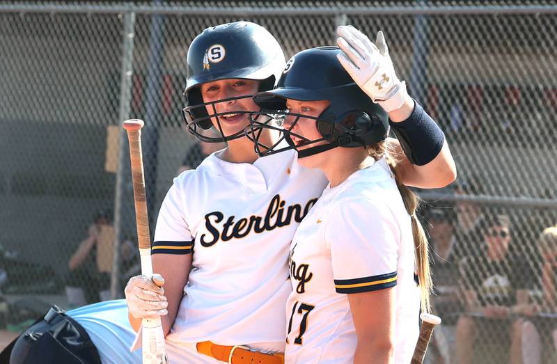 Sterling's Katie Dittmar (left) and Lauren Jacobs celebrate after Dittmar scored a run during their Class 3A sectional championship game against Sycamore Friday, June 2, 2023, at Belvidere North High School.