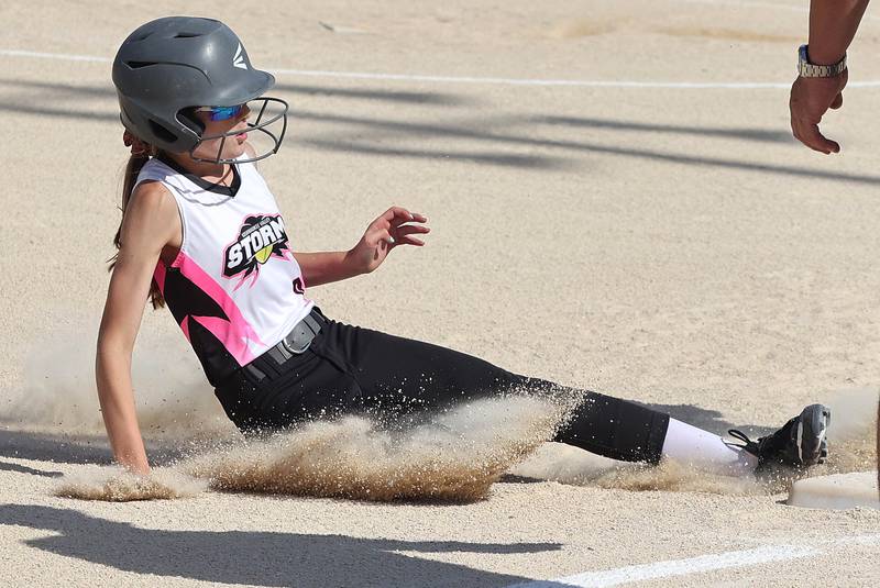Kishwaukee Valley Storm's Madison Butler slides safely into third Friday, June 24, 2022, during their 12u game against the Midwest Aftershock in the 22nd annual Storm Dayz tournament at the Sycamore Community Sports Complex.