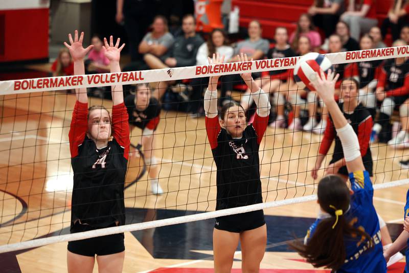 Bradley-Bourbonnais' Jamisen Parker, left, and Ella Haas jump to block a hit by Joliet Central's Mickalaynuh Wollenzien during their match at the Moldenhauer Classic tournament on Saturday, Oct. 18, 2025, at Bradley-Bourbonnais Community High School.