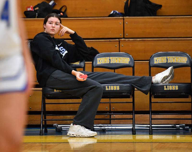 Lyons Township’s big scorer Emma O'Brien watches from the bench with an injury as her teammates take on Downers Grove North without her during a game on January 10, 2026 at Lyons Township High School in LaGrange.
