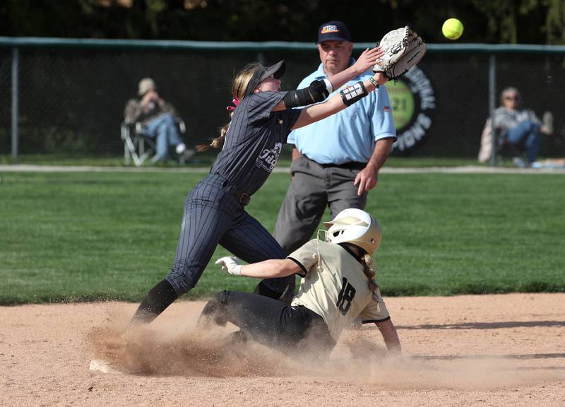 Sycamore's Addison McLaughlin slides in with a stolen base as Kaneland's Madison Anderson reaches for the throw during their game Wednesday, May 7, 2025, at Kaneland High School in Maple Park.