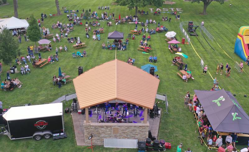 People watch bands play during the The Taste of the Illinois Valley on Friday, Aug. 1, 2025 at Centennial Park in Peru. The event featured food vendors, live music, a beer tent and a kids zone, Dreamwave wrestling and Pandora's Box, a Aerosmith tribute band.