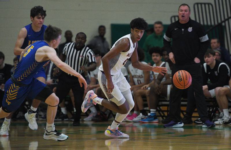 John Starks/jstarks@dailyherald.com
Rolling Meadow’s Cameron Christie brings the ball up court against Lyons Township as head coach Kevin Katovich gives direction in the Jack Tosh boys basketball tournament at York High School in Elmhurst on Friday, December 30, 2022.