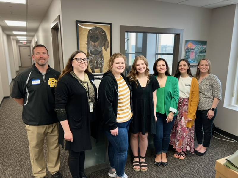Reed-Custer Principal Chad Klover, Art teacher Jessica Baron, Plainfield East Division Chair Cortny Troy, and Art teacher Elizabeth Pankau pose with first place contest winnder Alexandrea Faurot (center) and her sister.