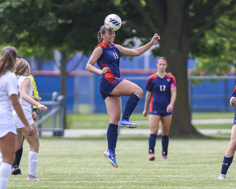 Oswego's Sophia Augustine (13) heads the ball during Class 3A regional final soccer match between Neuqua Valley at Oswego on Saturday, May 23, 2026 in Oswego.