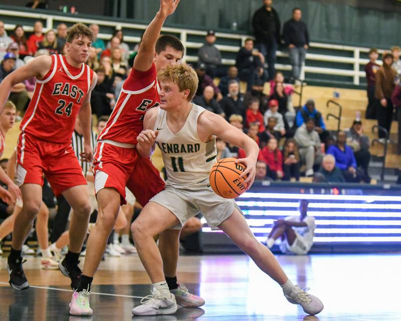 Glenbard West's Chase Cavan (11) drives to the basket and gets a shot off while being defended by Glenbard East Jacob Marynowski (15) on Wednesday Nov. 26, 2026, during the District 87 Thanksgiving Invitational held at Glenbard West High School.