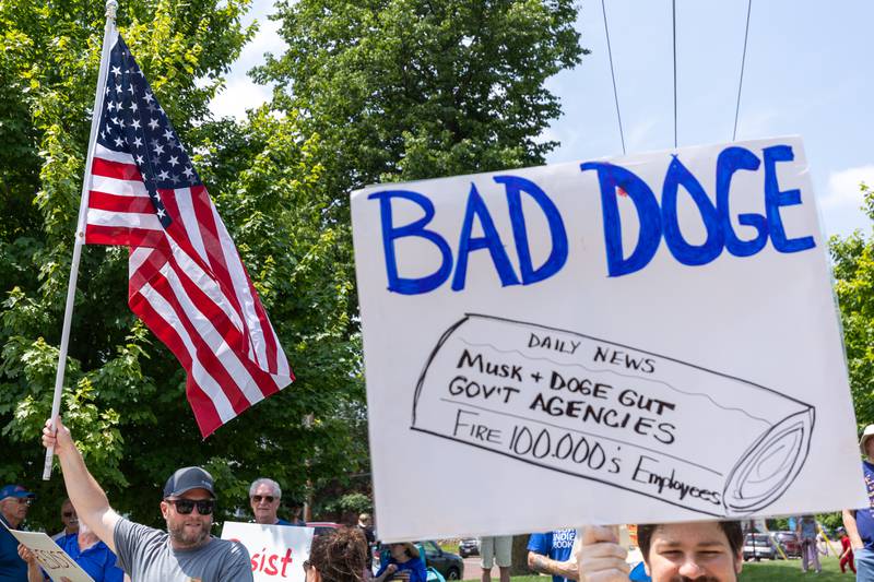 Protesters hold signs at the “No Kings“ protest on Saturday, June 14, 2025 at Rotary Park in Princeton.