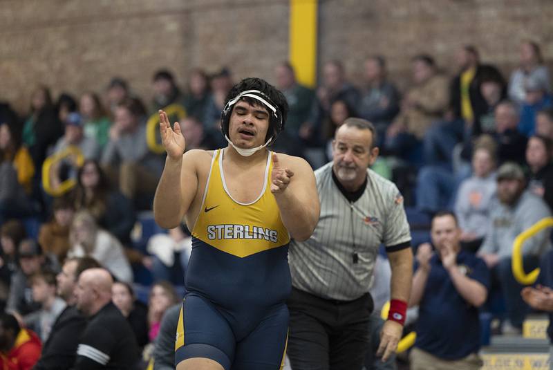 Sterling’s Javier Luna celebrates his pin of Jesse Hendrix of Galesburg in the 285 pound third place match at the Sterling wrestling regional.