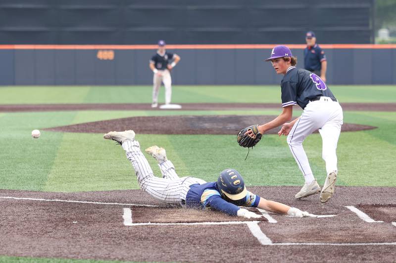 Ottawa Marquette’s Jaxsen Higgins slides safely across home plate during the Crusaders' 16-1 victory over Lexington in the IHSA Class 1A State semifinal on Friday, June 6, 2025.
