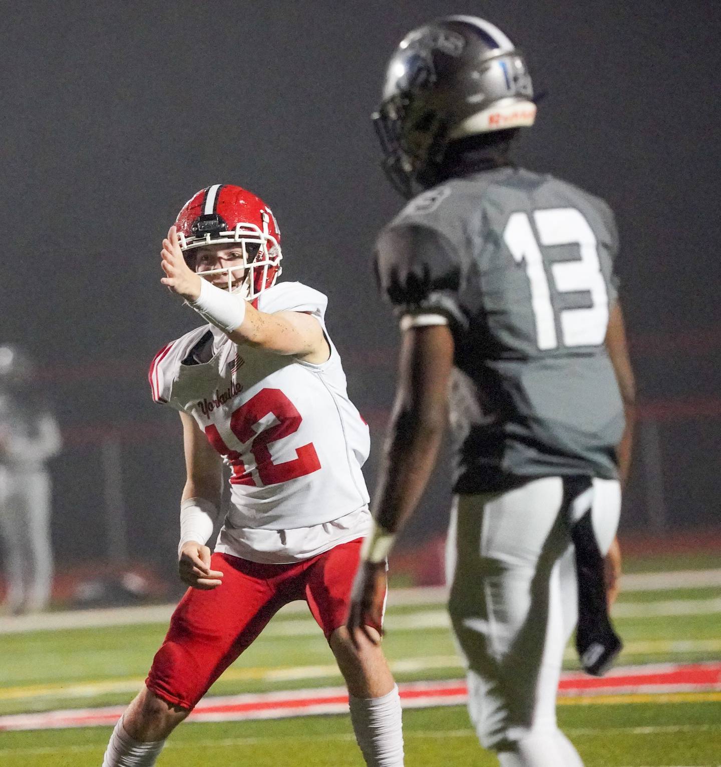 Yorkville's Jack Ferguson (12) signals for a first down after intercepting a pass against Oswego East during a football game at Yorkville High School on Friday, Oct. 13, 2023.