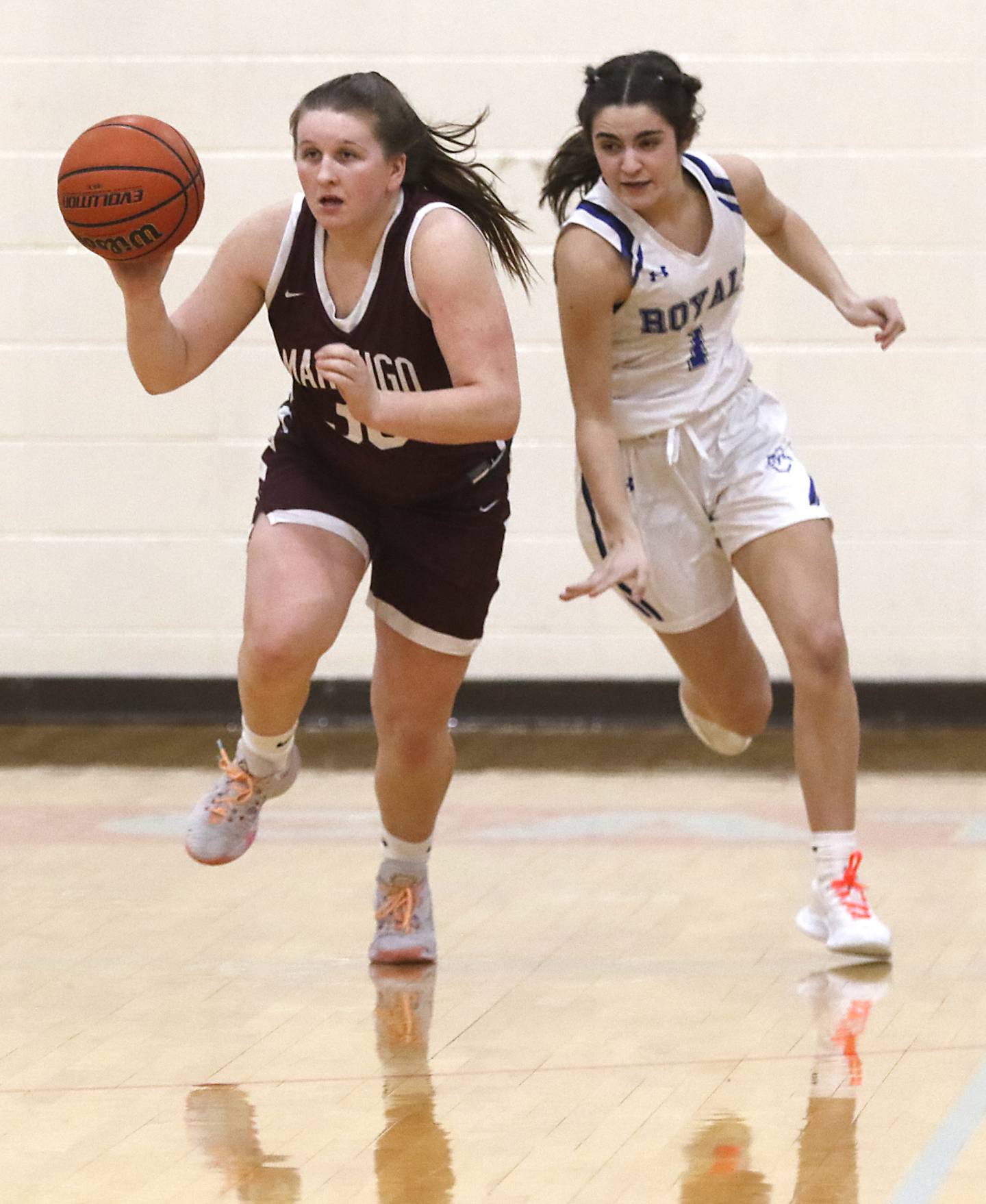 Marengo’s Addie Johnson pushes the ball up the court against Rosary’s Megan Molenhouse during a IHSA Class 2A Regional semifinal basketball game Monday evening, Feb. 14, 2022, between Marengo and Rosary at Marian Central High School.