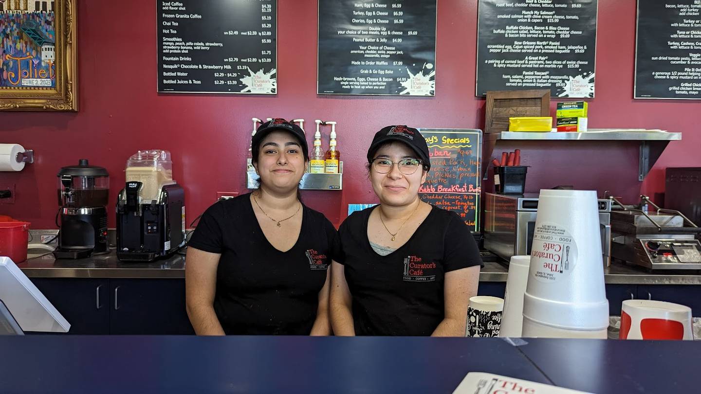 Two employees at The Curator's Cafe in Joliet, Emily Salazar (left) and Marissa Cervantes (right) participated in the cafe's recent paint night. Salazar and Cervantes have been friends since preschool and each painted a corner in the other's painting.