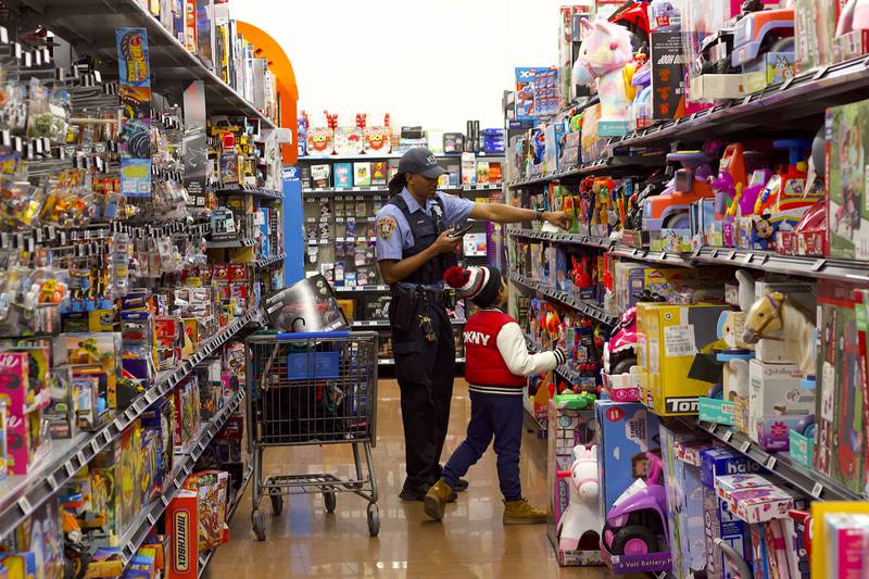 Joliet Police Officer Dazrion Green shops with a child during the 36th annual Santa's Cops event on Saturday, Dec. 6, 2025, at Walmart, 401 Illinois Route 59, in  Shorewood.