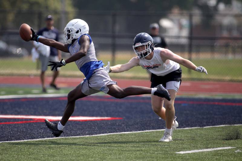 A St. Francis player reaches for a touchdown during a 7-on-7 football tournament at West Aurora High School on Friday, June 23, 2023.