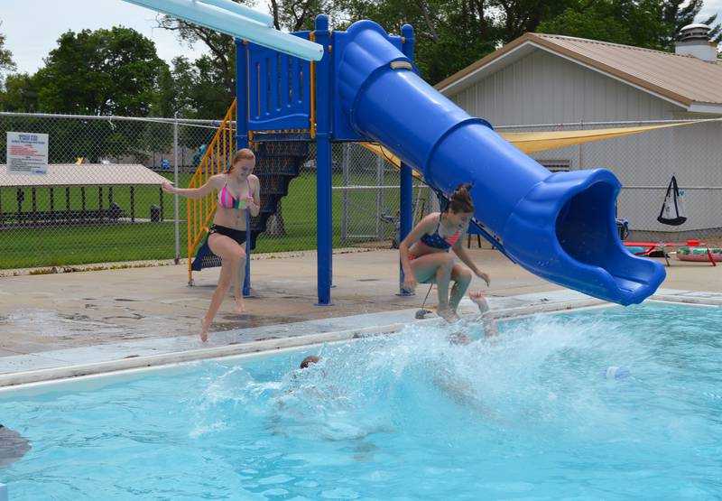 Layney Mumford, 15, left, and Zandra Vock, 12, mid-air, follow friends Leeanne Diaz, 15, and Reagan Grenoble, 15, into the Polo pool at Keator Park on May 28. The pool opened on May 27 for the 2022 season.