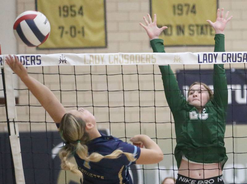Marquette's Greysyn Carrier reaches up to spike the ball to St. Bede's Lili McClain on Thursday, Sept. 4, 2025 at Bader Gym.