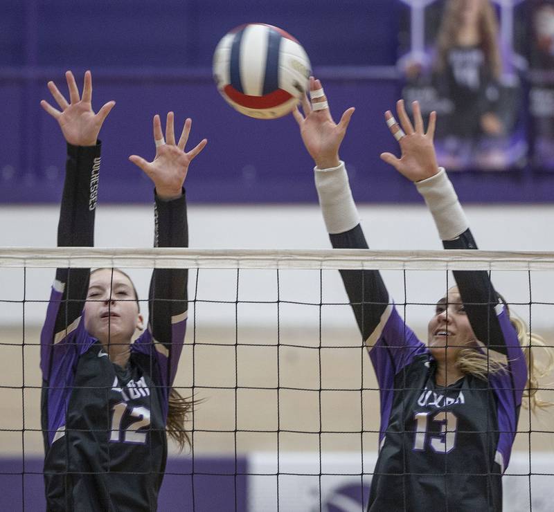 Dixon’s Izzy Queckboerner (left) and Solis Thompson go up to block a shot against Rochelle Thursday, August 28, 2025.