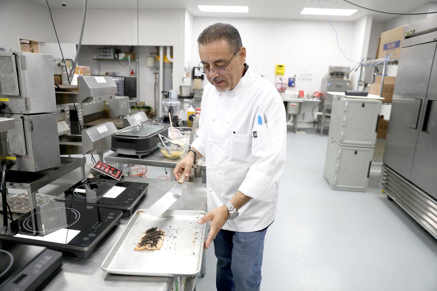 Mario Arevalo, operations manager, works in the kitchen at Keto Factory, formerly AJ Sliders, which opened in September 2020 at 2075 Prairie St., Suite 110 in St. Charles.  Keto Factory specializes in wheat-free, gluten-free, sugar-free, and soy-free foods and offers on-the-go meals as well as market produce and meal plans.