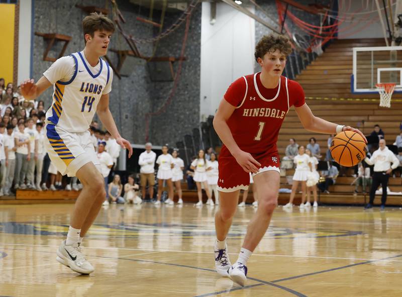 Hinsdale Central's Kristopher Dowell (1) dribbles during a varsity basketball game between Hinsdale Central and Lyons Township high schools on Friday, Dec. 12, 2025 in La Grange.